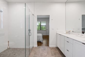 a bathroom with a shower and a sink and a bedroom at Odyssey, Florida, 33905